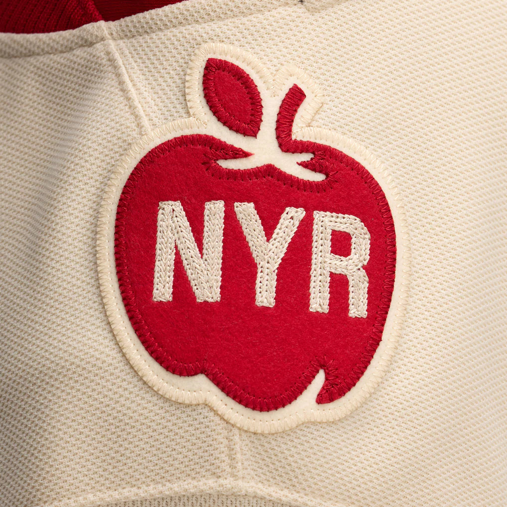Red apple patch with 'NYR' on a beige background