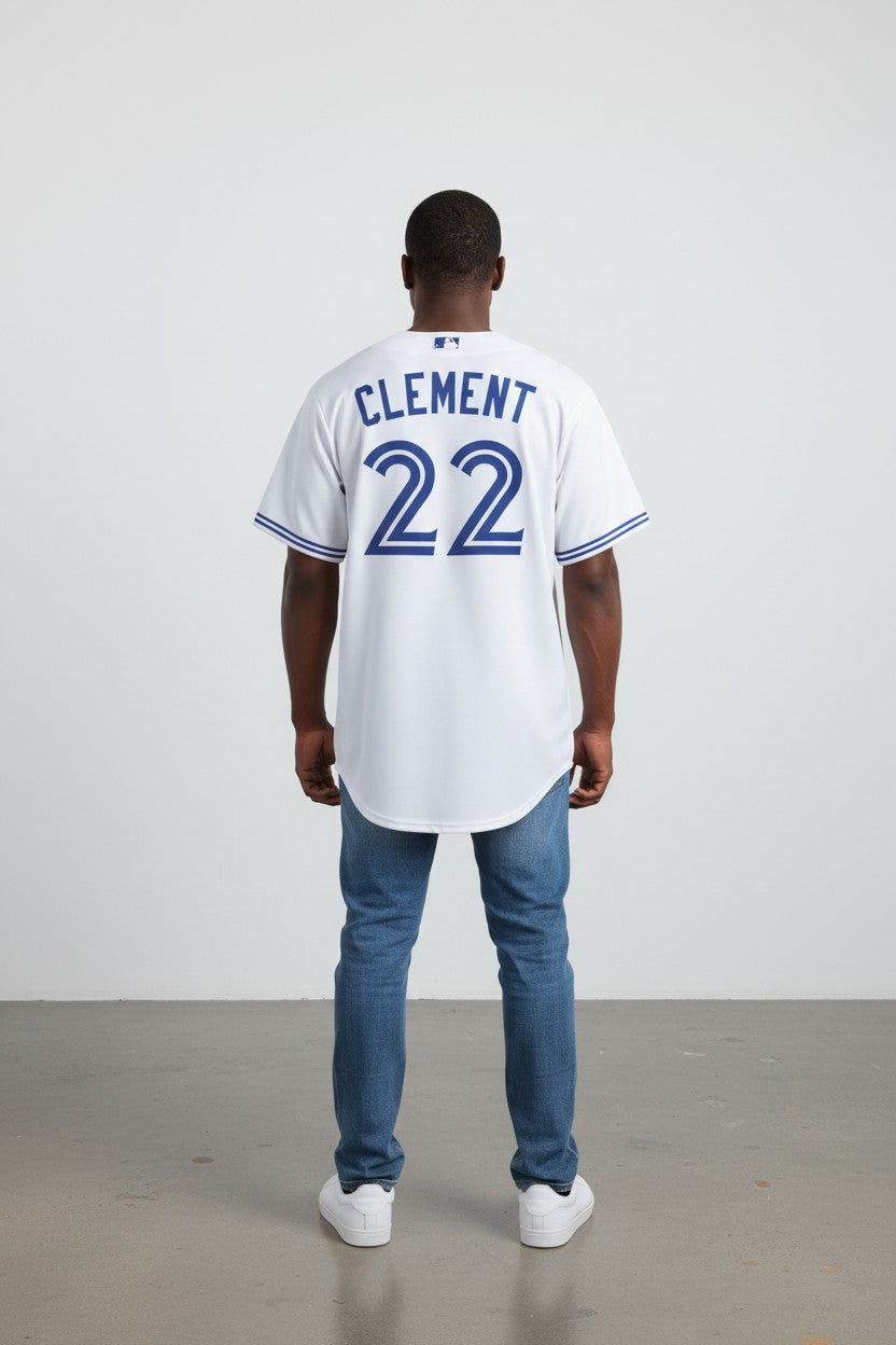 Person wearing a white baseball jersey with 'Clement 22' on the back, standing against a plain background.